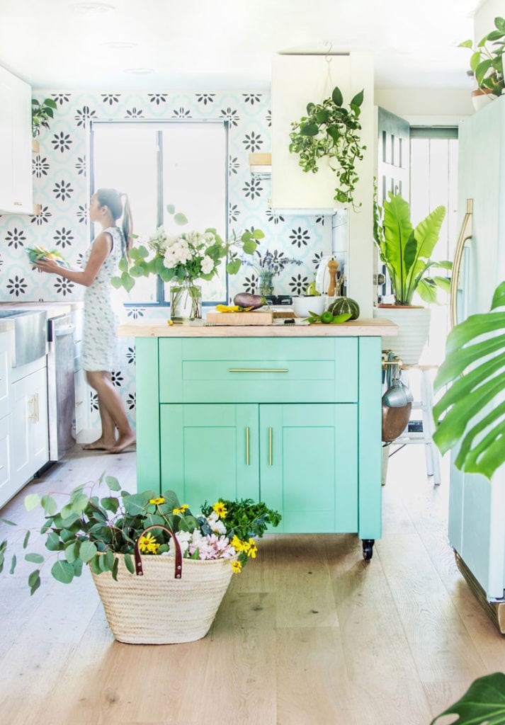 anthropologie style farmhouse kitchen with colorful island