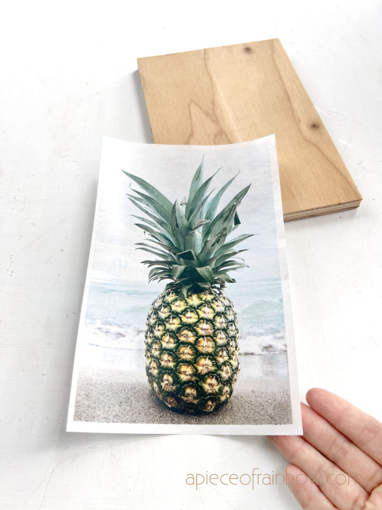 a printed pineapple photo and a piece of wood