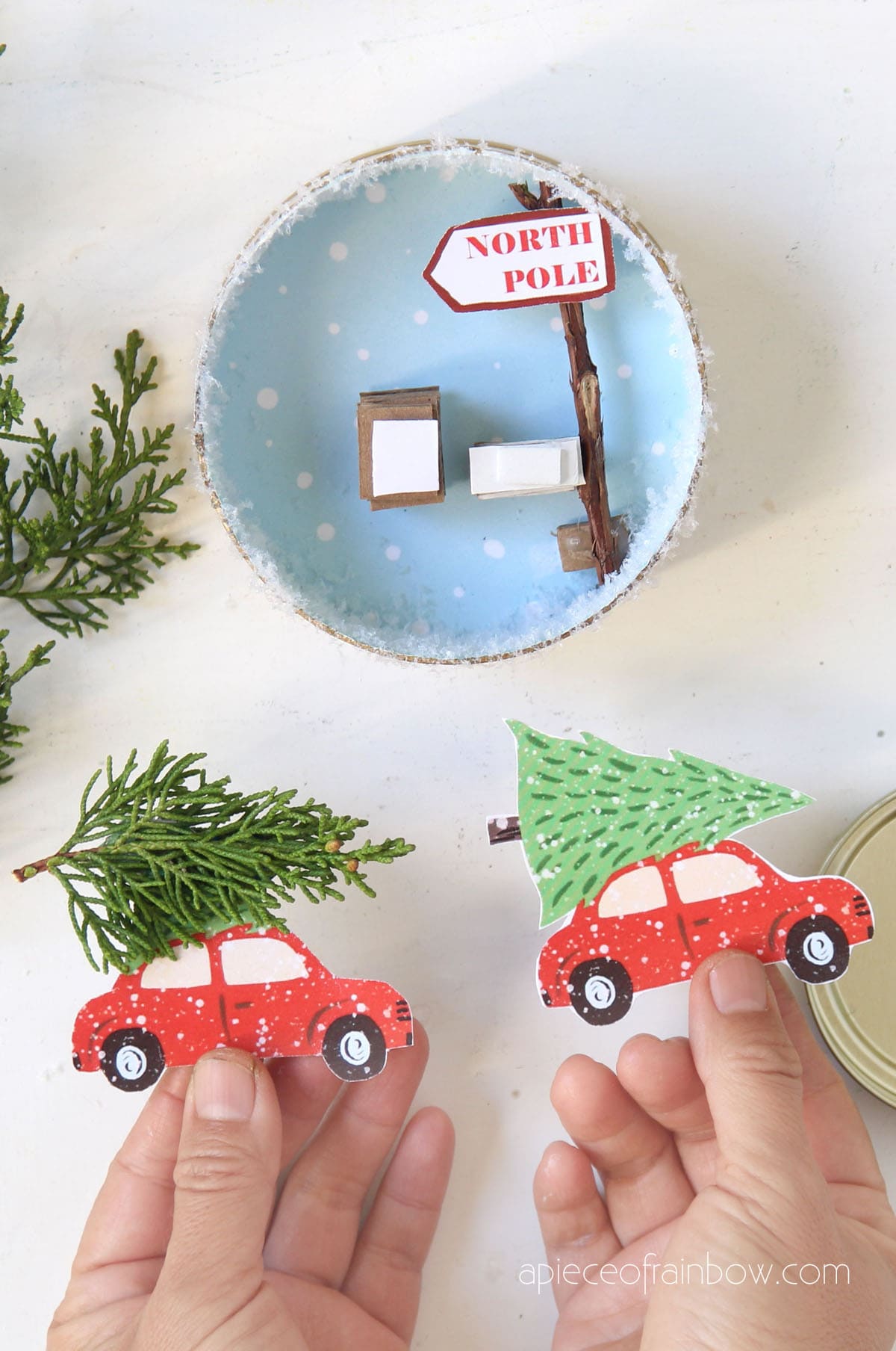 attach the red car and Christmas tree cutout to cardboard stacks inside ornament