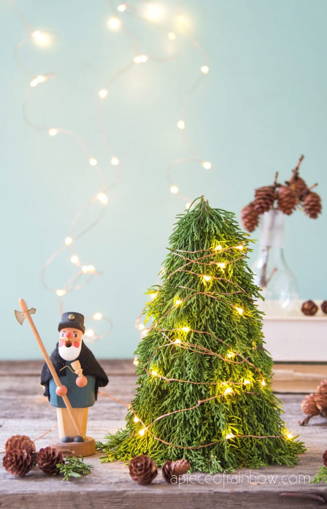 lighted mini Christmas tree on table