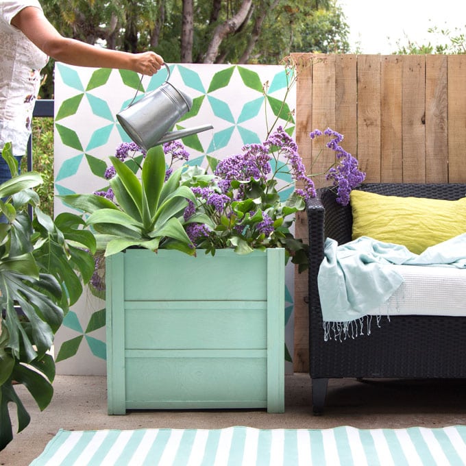 Make beautiful wood planter boxes easily for $10, using simple tools. Lightweight, portable, and long lasting, these large planter pots look amazing on a patio or deck. Free planter box plans included! - A Piece of Rainbow