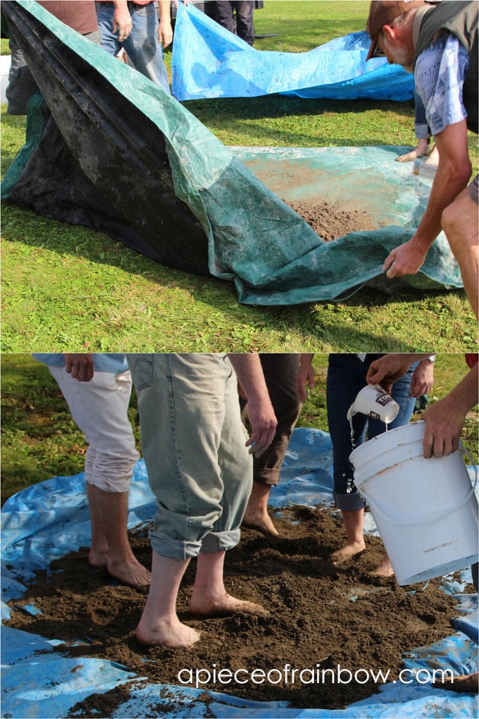 mixing water, sand and clay to build DIY wood fired outdoor pizza oven, aka cob / earth oven