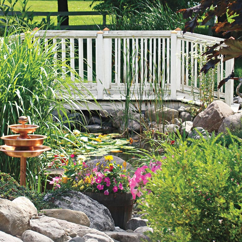 beautiful white garden bridge over a pond