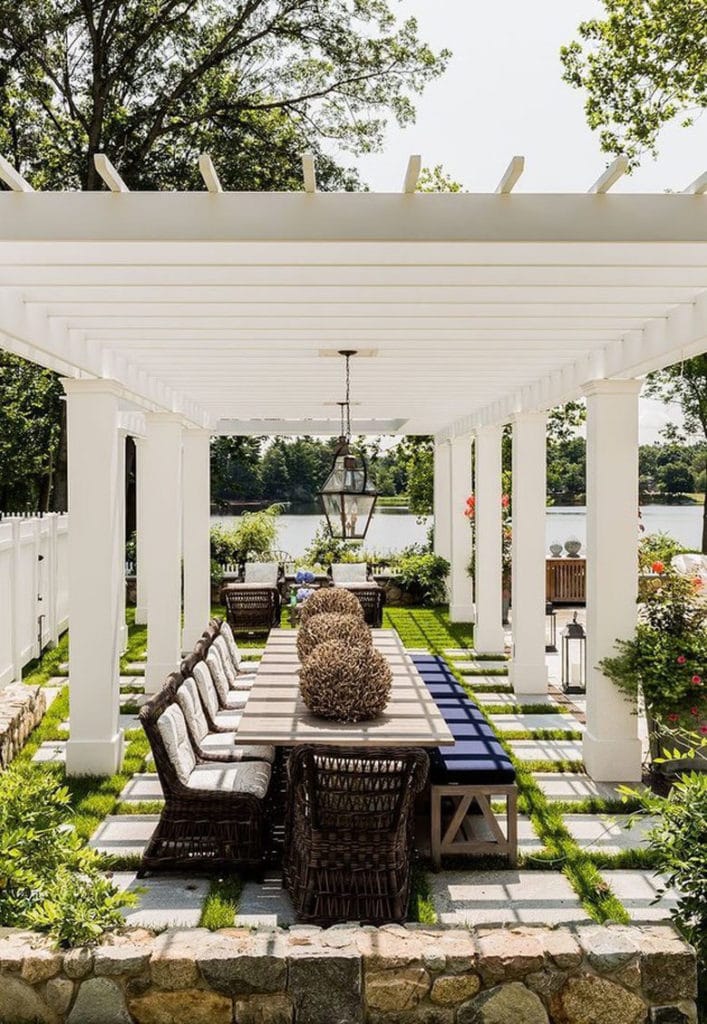 backyard garden with free standing pergola painted white