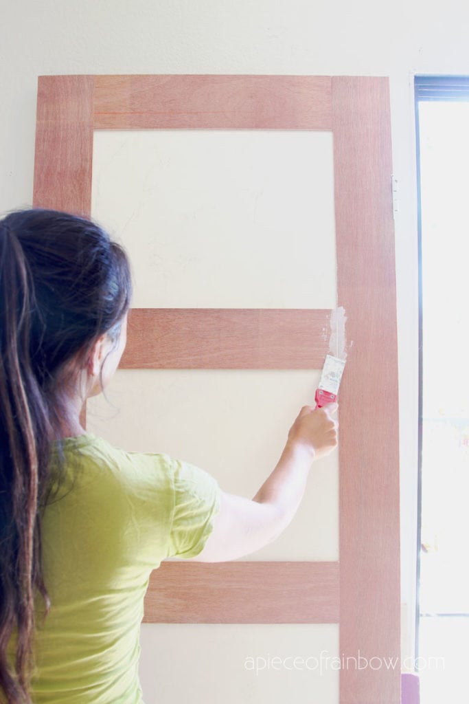 smooth out gaps on door design with  spackling paste or joint compound 