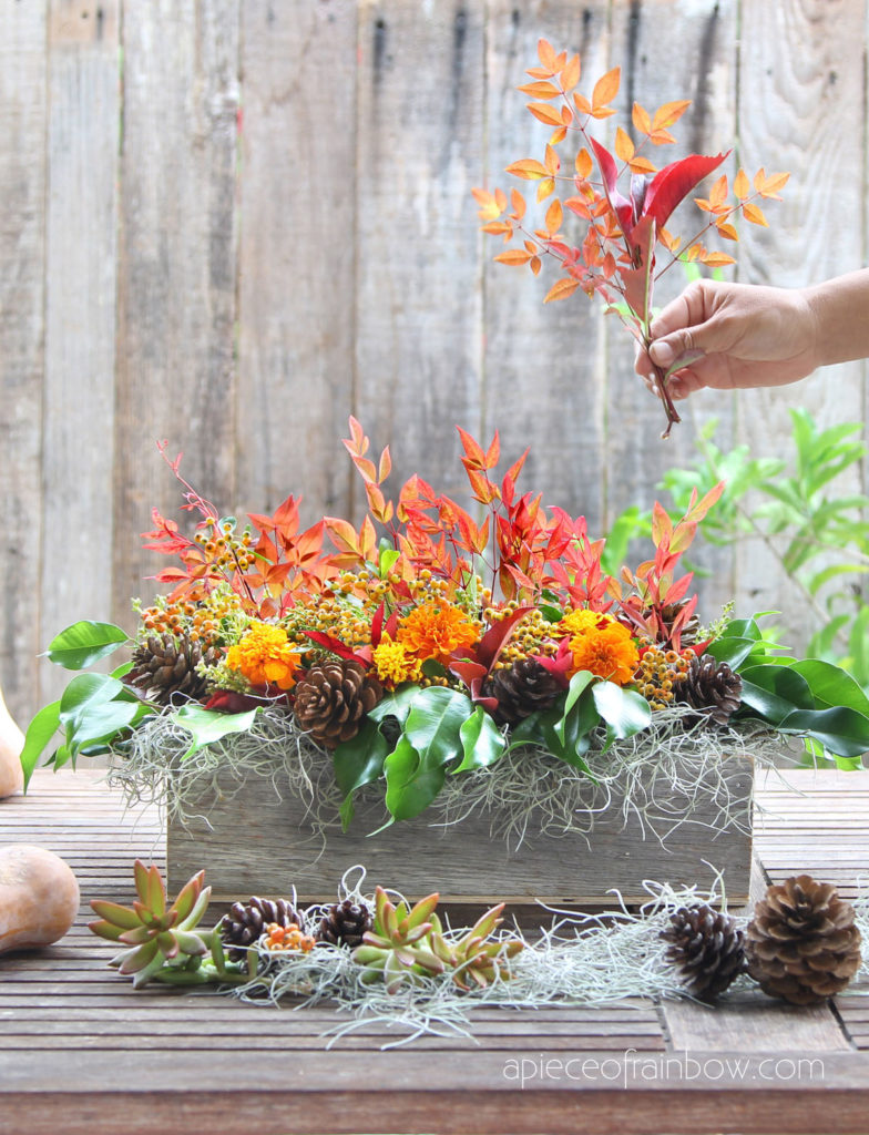 Fall and Thanksgiving table decorations with colorful leaves 