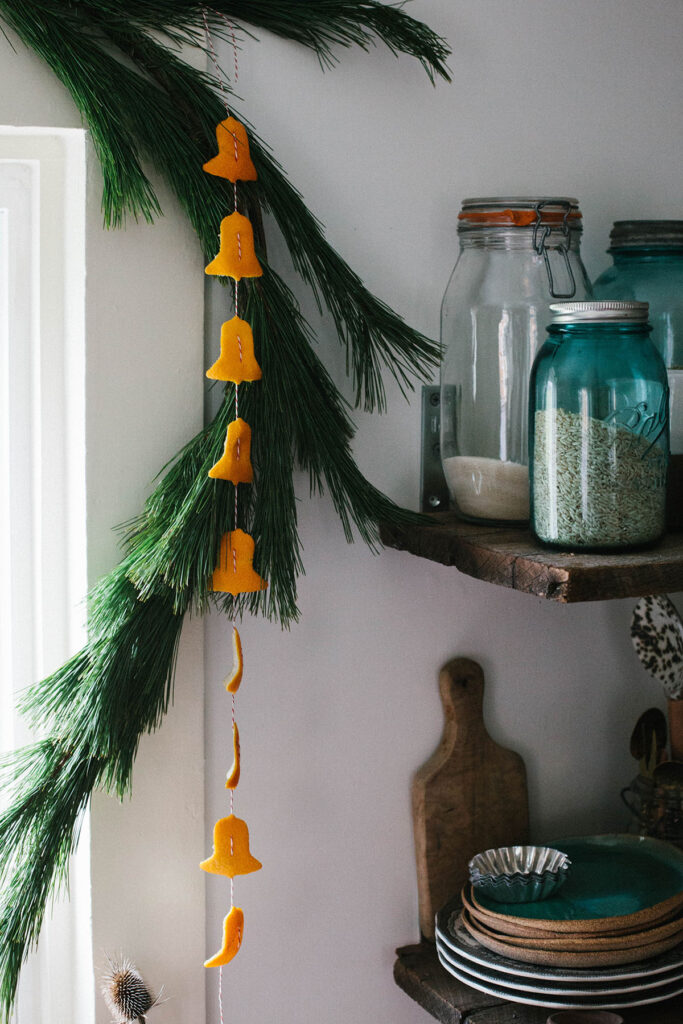 decorate kitchen window with DIY orange peel Christmas garland 