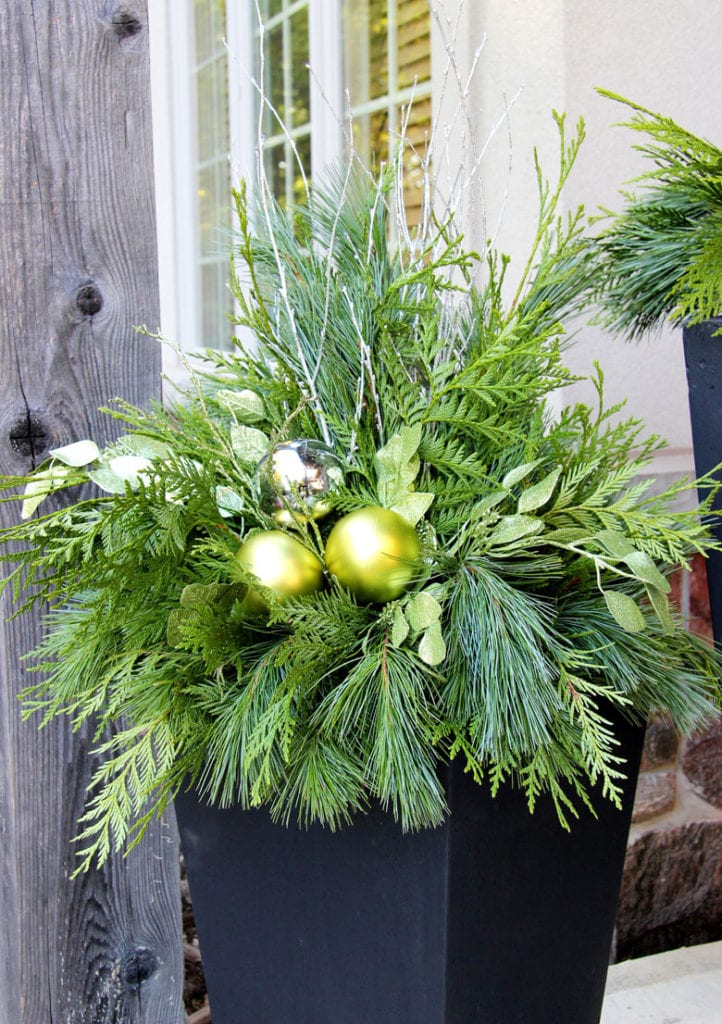 Chartreuse green ornaments in winter planter