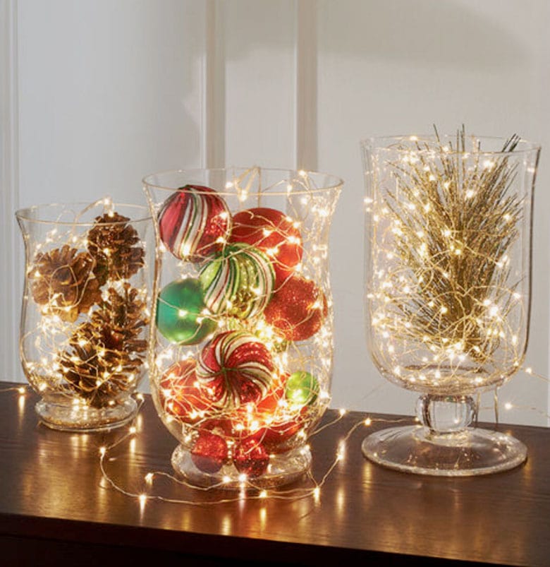 glass hurricane vases with conifer branches, LED candles, pine cones, or LED fairy lights.